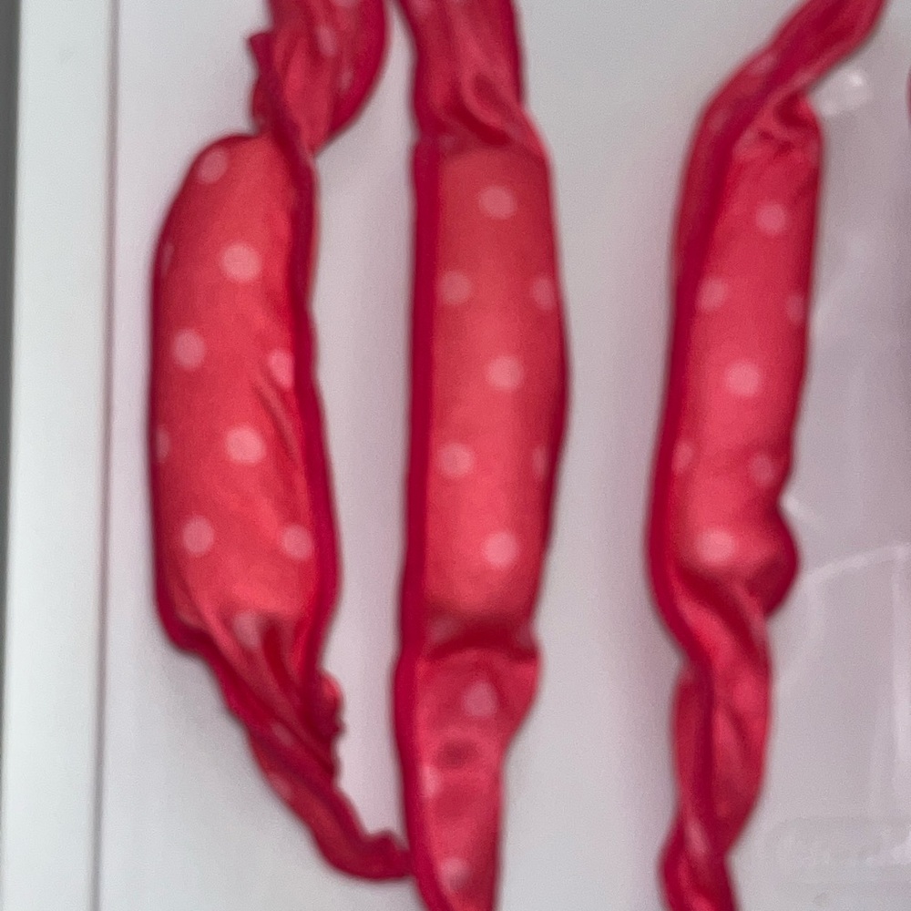 Cloth hair rollers, pink in color